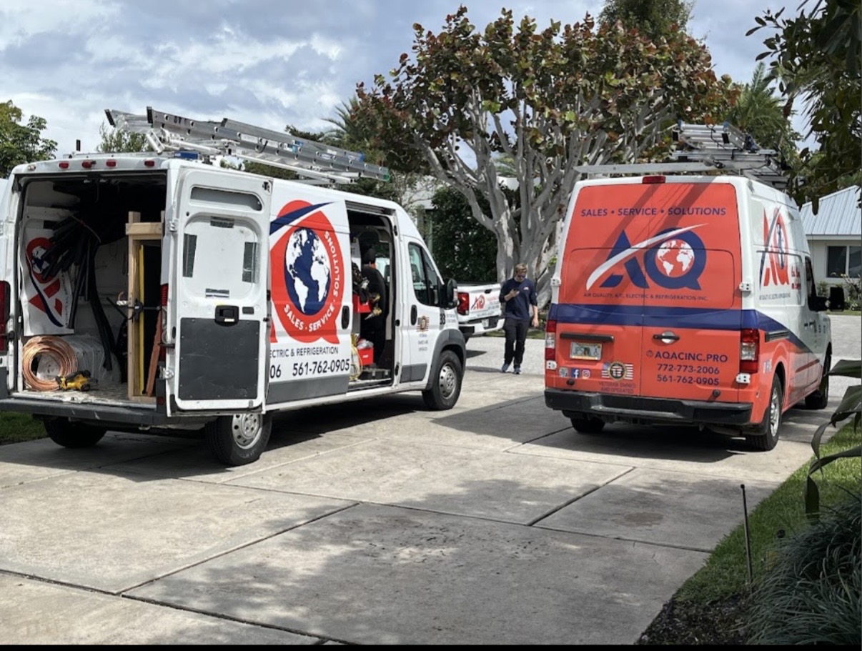 AQ AC & Electric service vans on a job in Palm Beach County